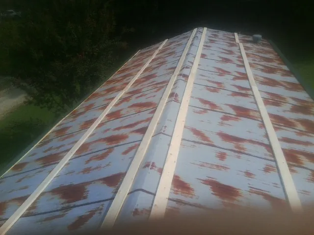 Rusted metal roof panels with new wood purlins before replacement — Storm Damage Roof Repair in Wolcott by Roofing Brothers